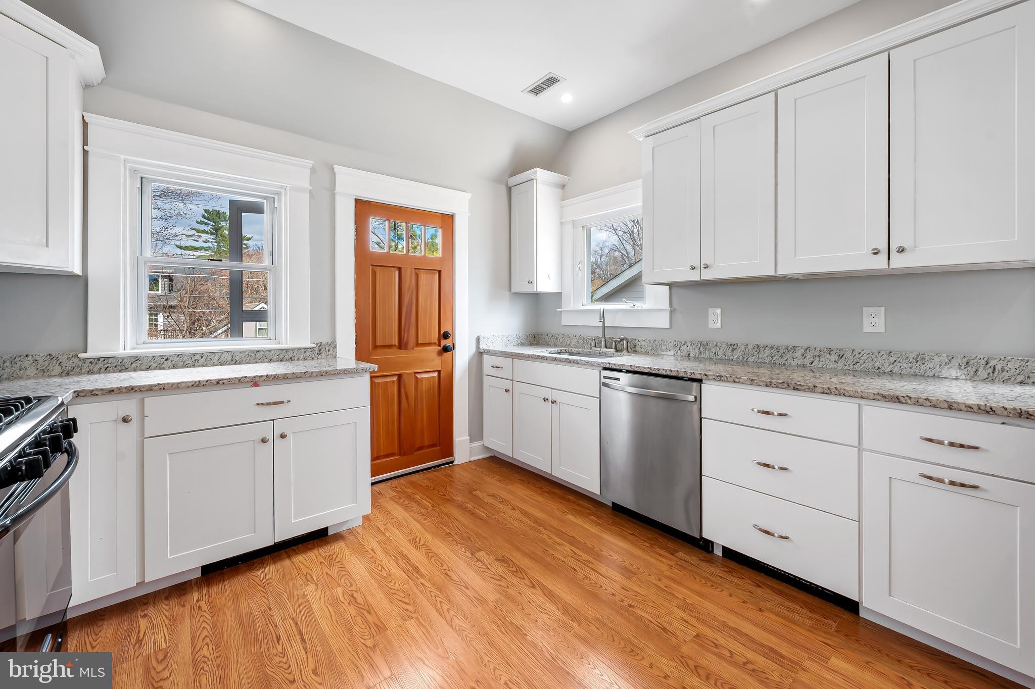 630 Dunkirk Road Baltimore, MD 21212 - Photo 10 of 36 a white kitchen with granite countertop stainless steel appliances