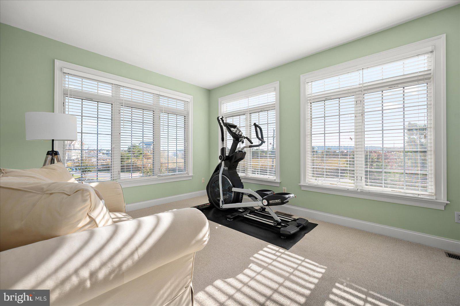 12901 Old Bridge Road, Unit PH8 2 Ocean City, MD 21842 - Photo 28 of 79 a view of a room with gym equipment and a large window