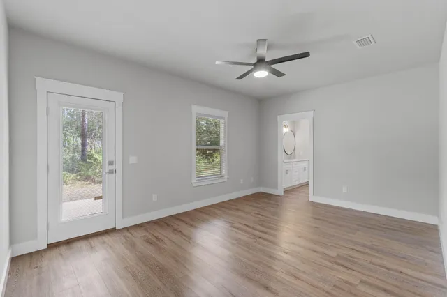 a view of an empty room and wooden floor