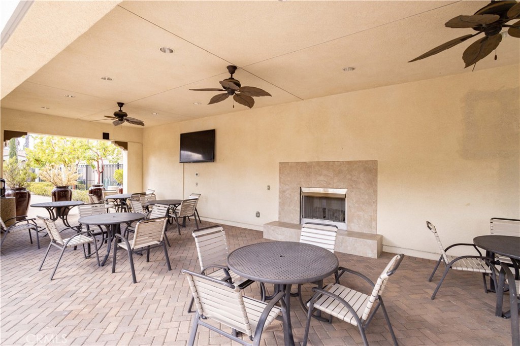 20335 Paseo Meriana Porter Ranch, CA 91326 - Photo 38 of 58 Resort-Style Community Seating Area with Fireplace and TV
