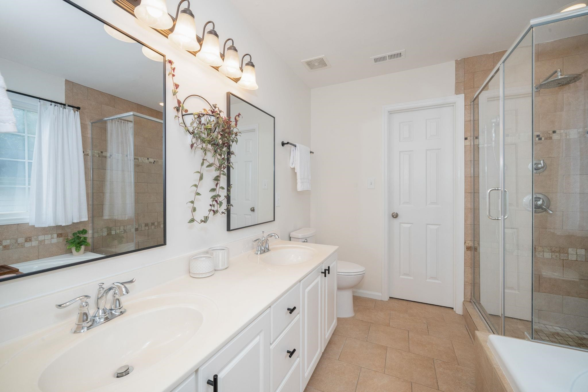 8813 Harps Mill Road Raleigh, NC 27615 - Photo 17 of 28 a bathroom with a double vanity sink mirror and double