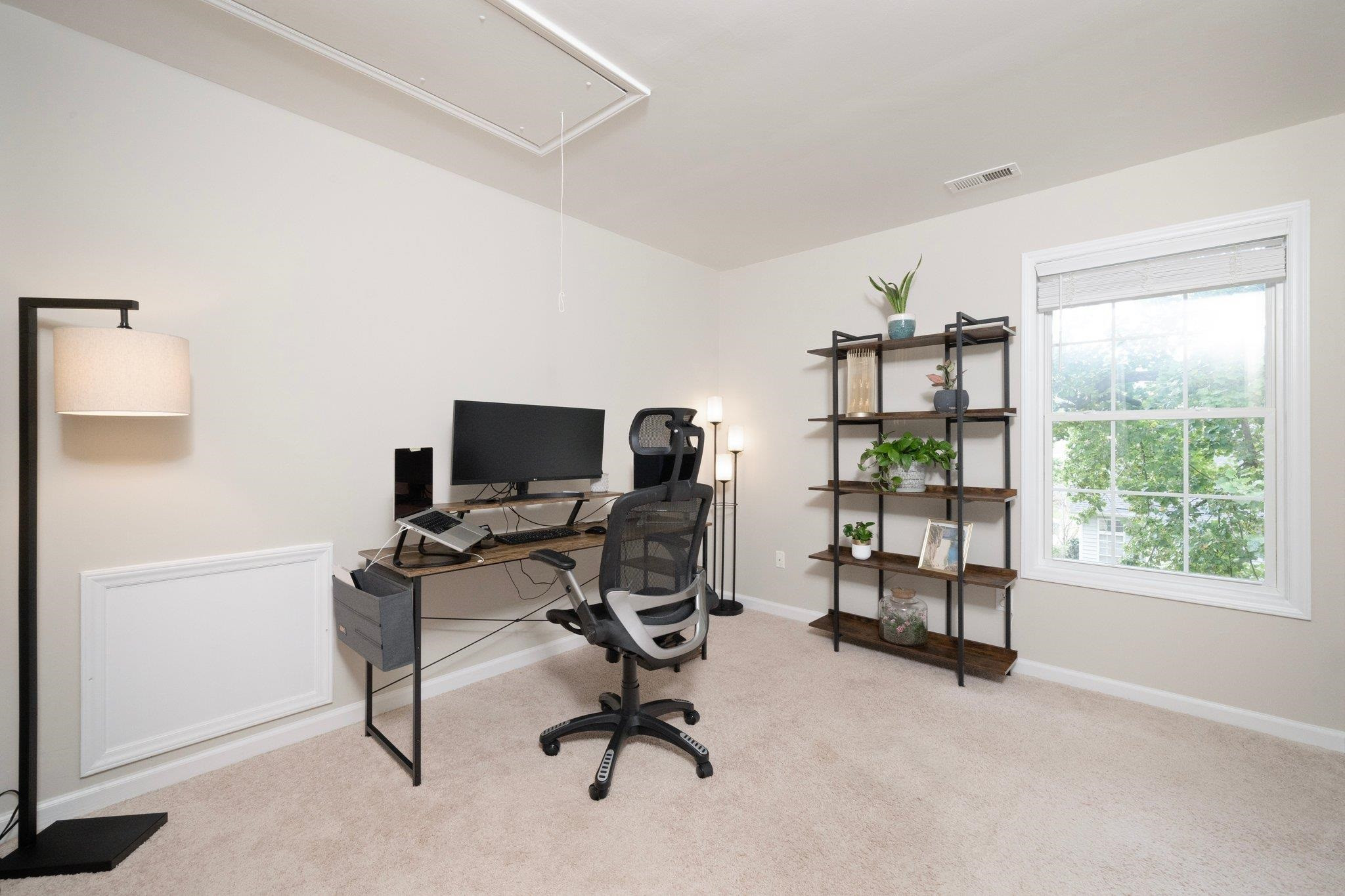 8813 Harps Mill Road Raleigh, NC 27615 - Photo 21 of 28 a view of a workspace with furniture and a window