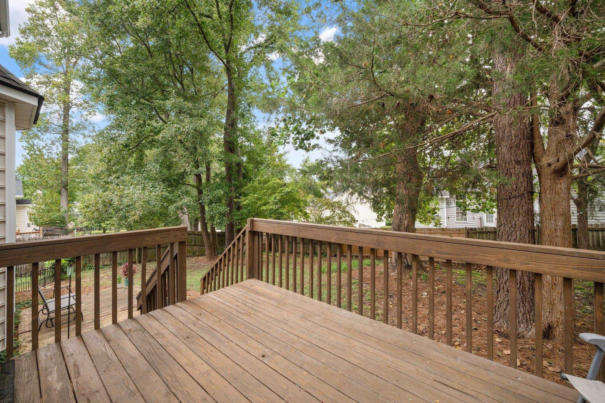 8813 Harps Mill Road Raleigh, NC 27615 - Photo 23 of 28 a balcony with wooden floor and fence