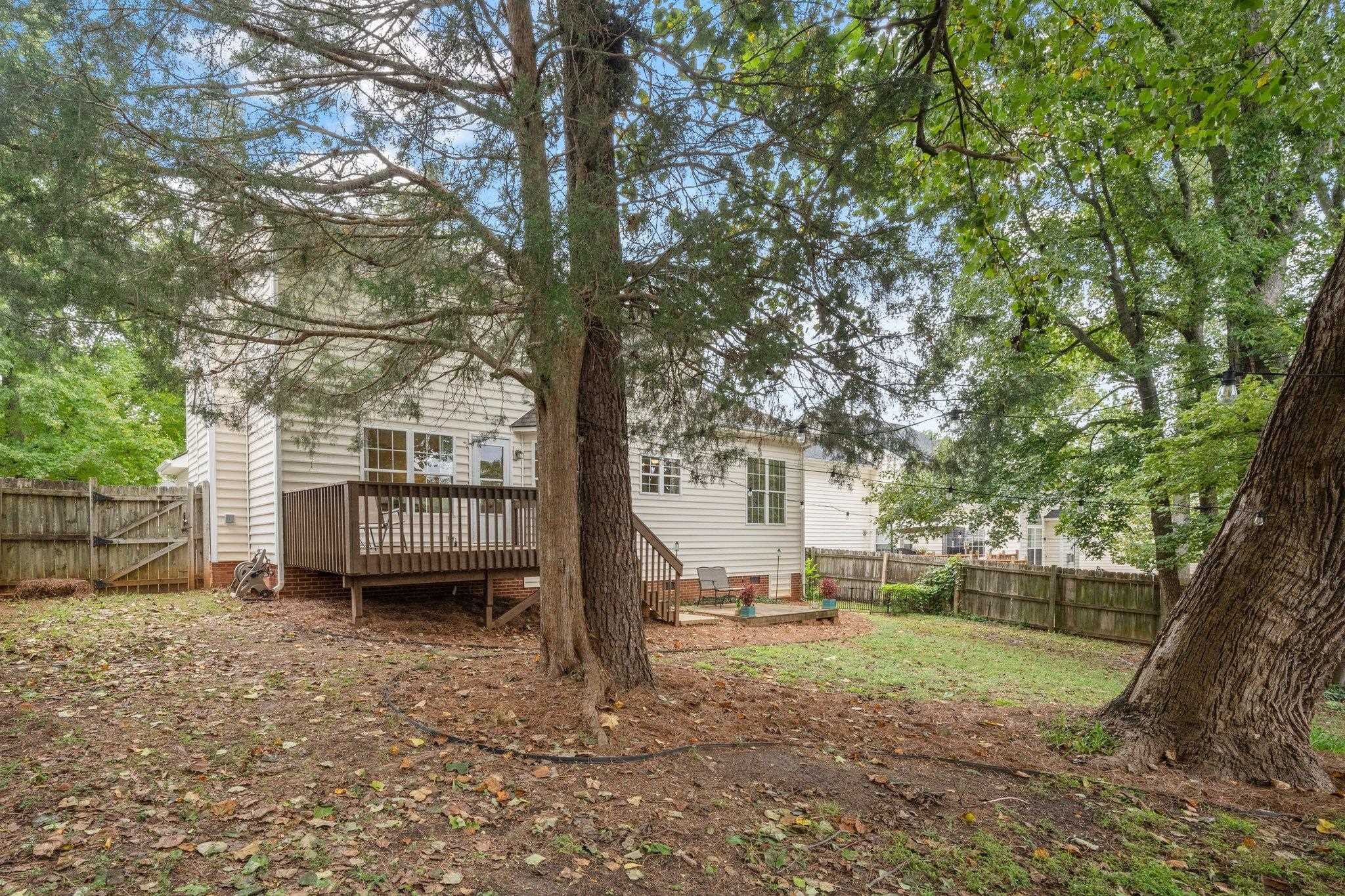 8813 Harps Mill Road Raleigh, NC 27615 - Photo 27 of 28 a view of a house with backyard and a trees