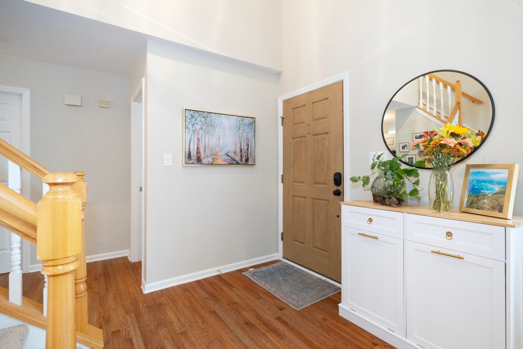 8813 Harps Mill Road Raleigh, NC 27615 - Photo 5 of 28 a view of a hallway with wooden floor