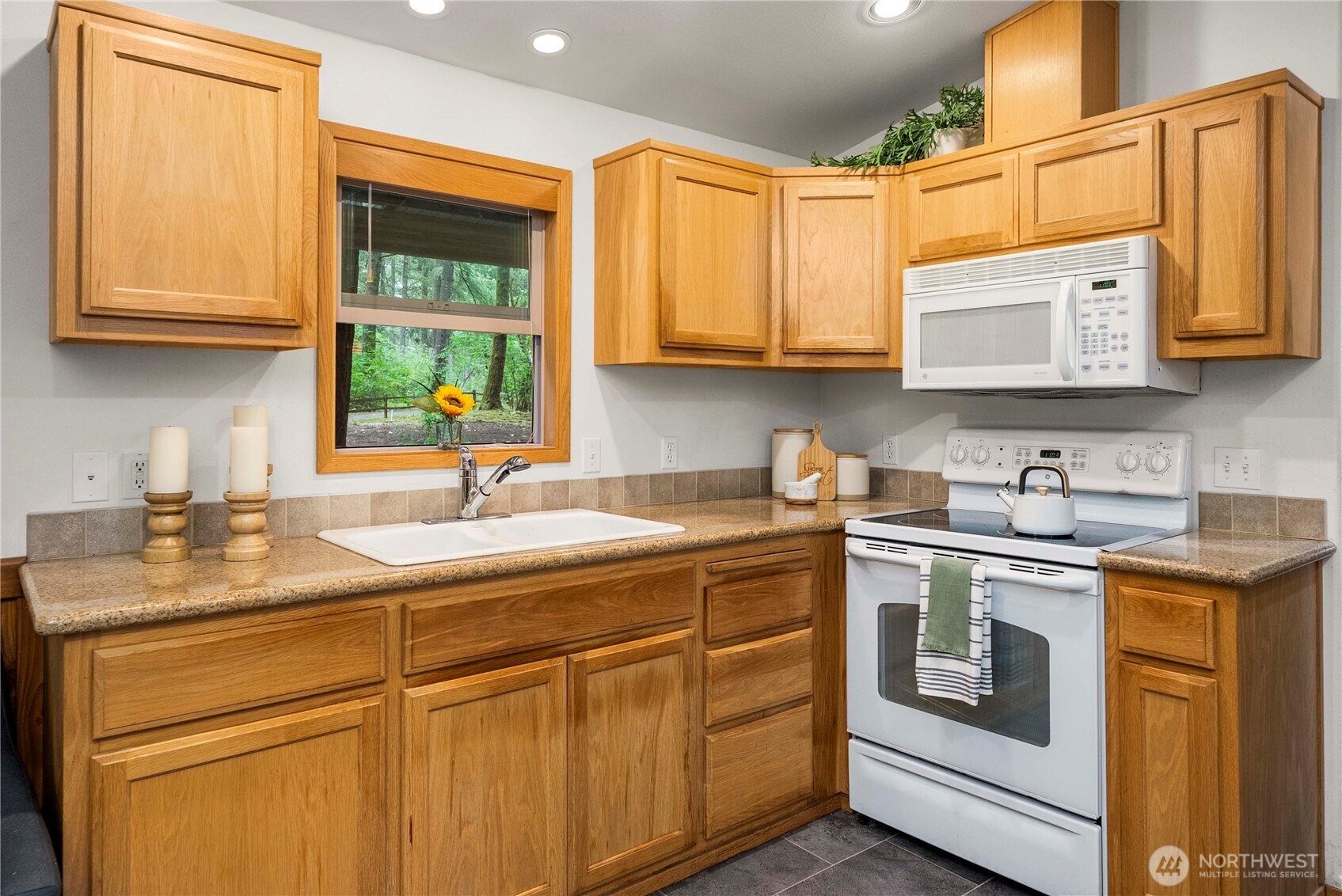1546 Reservation Road Southeast, Unit 62 Olympia, WA 98513 - Photo 7 of 39 a kitchen with stainless steel appliances granite countertop a sink a stove and cabinets