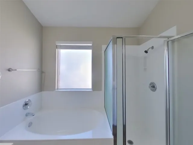 a bathroom with a bathtub and a shower