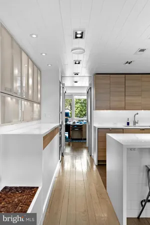 a view of living room with stainless steel appliances kitchen island a table and chairs