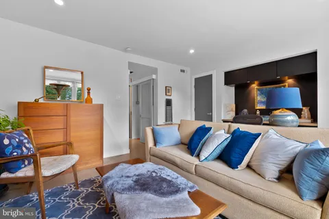 a living room with furniture and a lamp