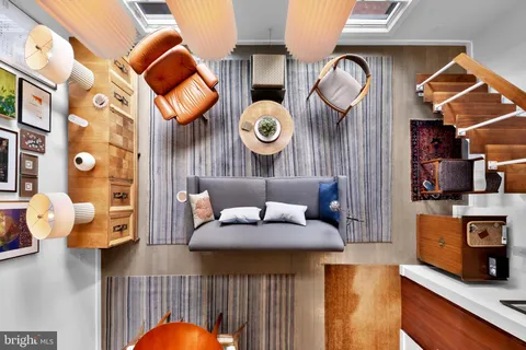 a kitchen with stainless steel appliances granite countertop a table chairs sink and cabinet