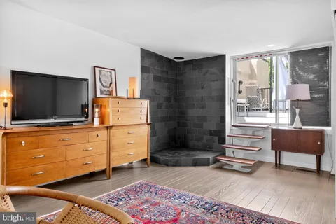 a view of a livingroom with furniture and a floor to ceiling window