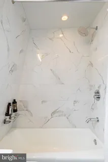 a bedroom with a bed and large window