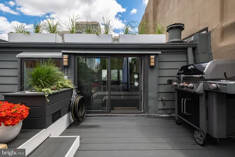 a bedroom with a bed and glass window