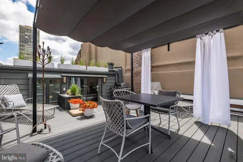 a large bedroom with a bed and a flat screen tv