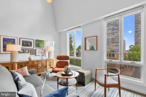 a view of a kitchen with a sink and dishwasher with wooden floor