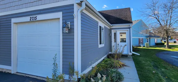 a backyard of a house with plants and tree