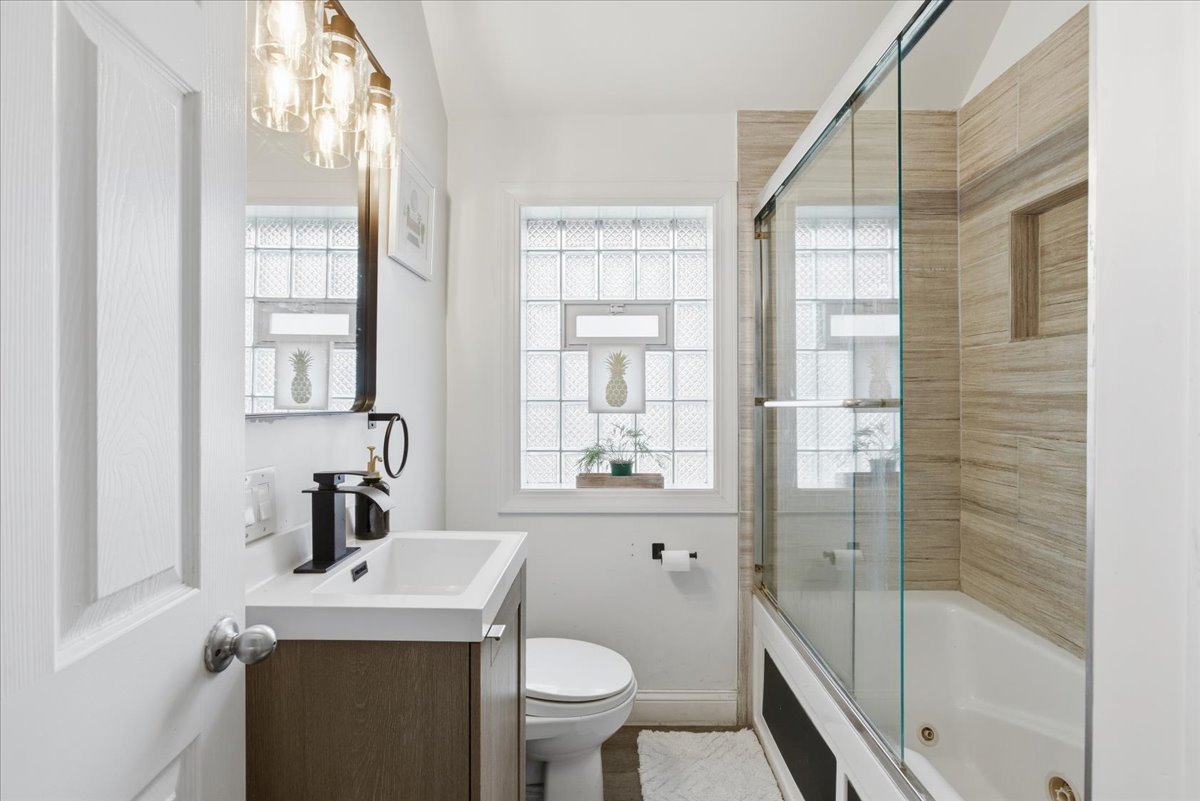 7802 West Victoria Street Chicago, IL 60631 - Photo 8 of 10 a bathroom with a sink toilet and shower