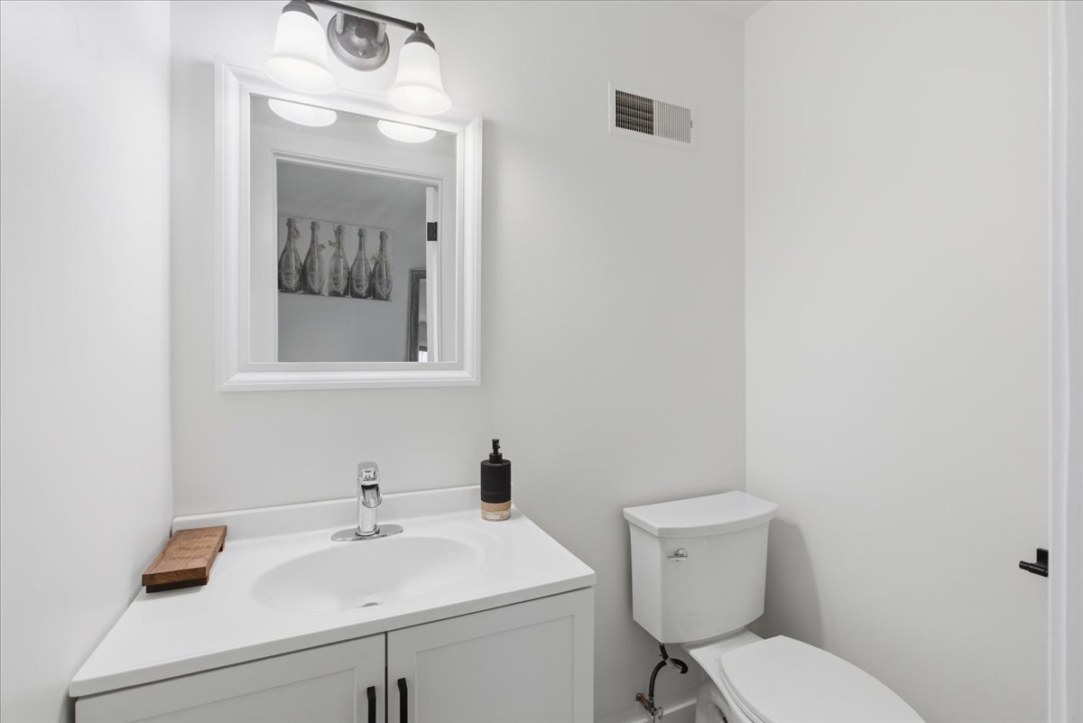 7802 West Victoria Street Chicago, IL 60631 - Photo 9 of 10 a bathroom with a toilet sink and mirror