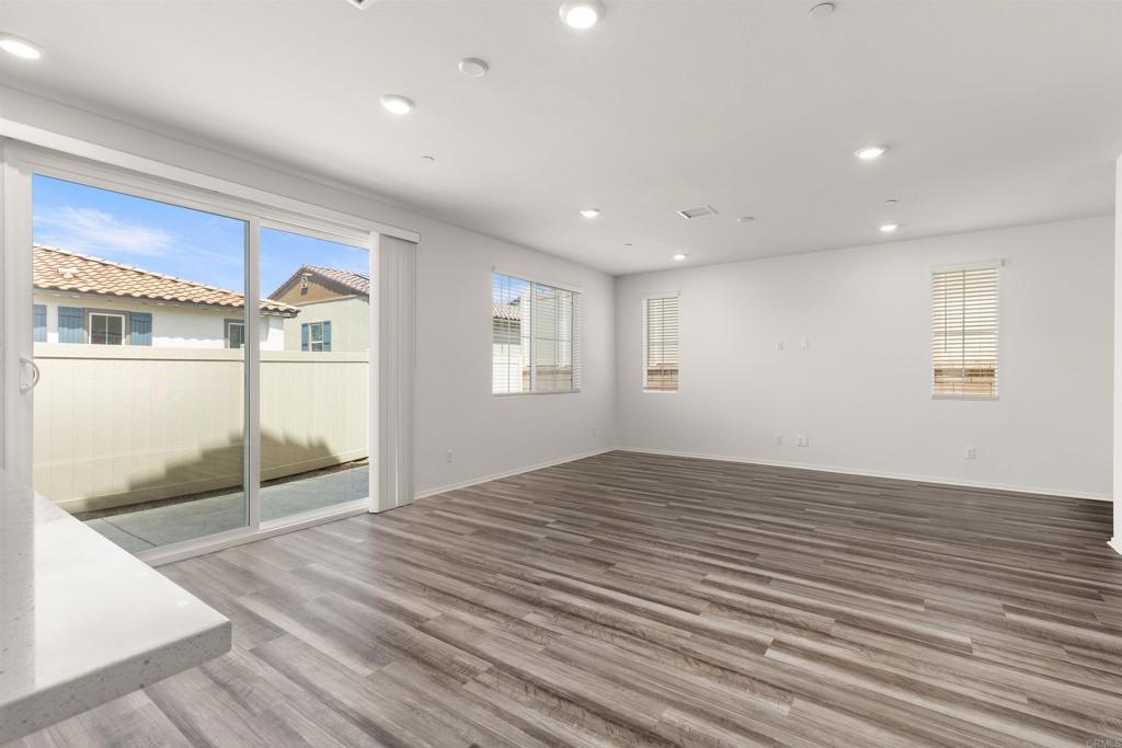 895 Brookdale Drive Vista, CA 92081 - Photo 12 of 45 a view of an empty room with wooden floor and a window