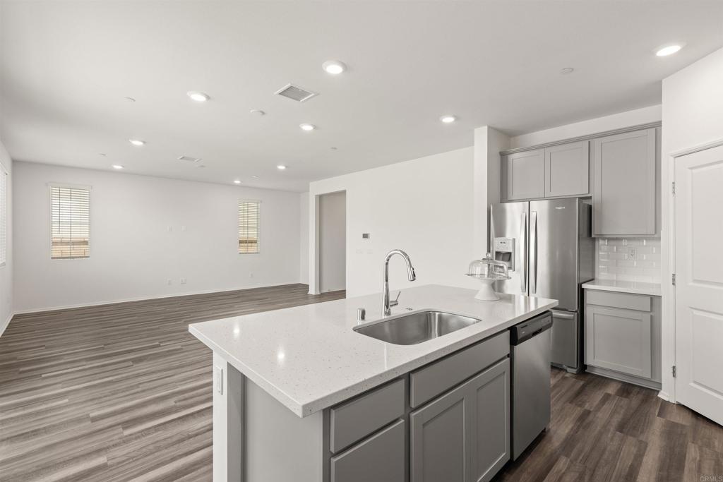 895 Brookdale Drive Vista, CA 92081 - Photo 19 of 45 a kitchen with kitchen island a sink appliances and cabinets