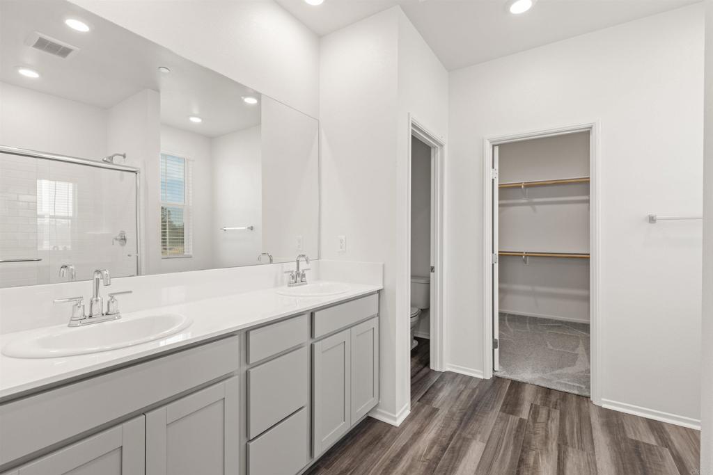 895 Brookdale Drive Vista, CA 92081 - Photo 23 of 45 a bathroom with a sink double vanity and a mirror