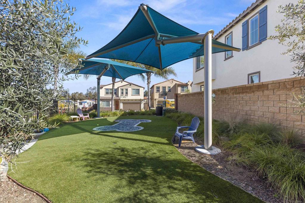 895 Brookdale Drive Vista, CA 92081 - Photo 38 of 45 a view of a yard with a table and chairs under an umbrella