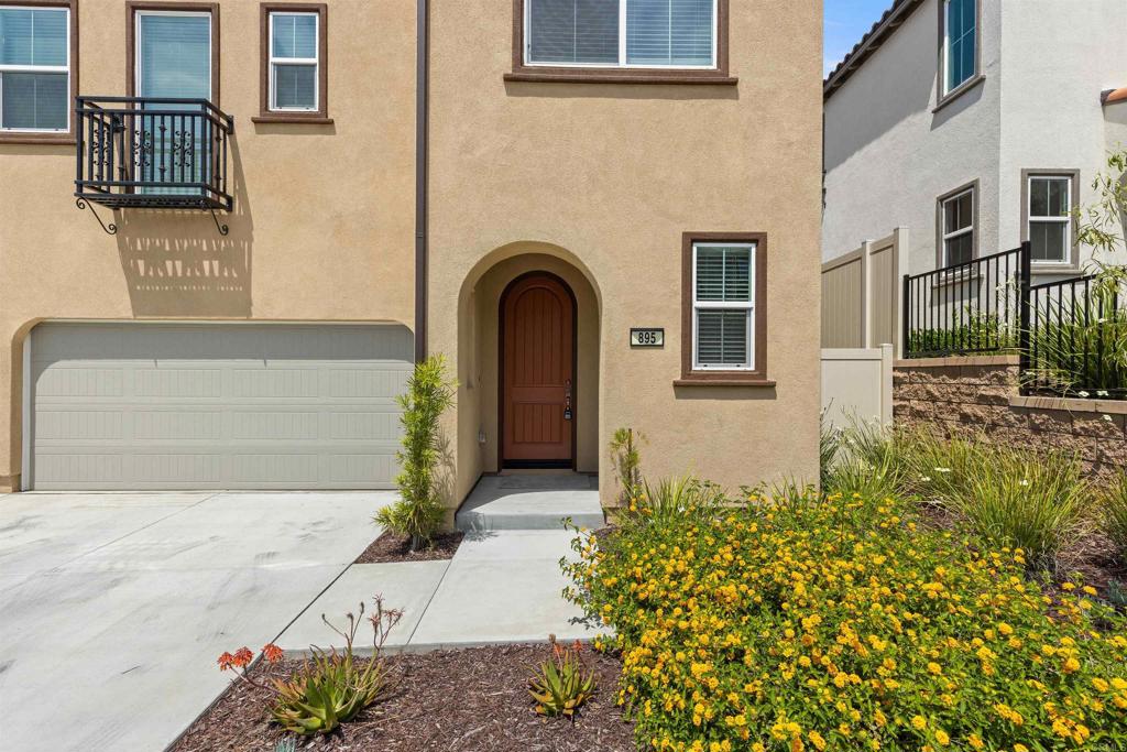 895 Brookdale Drive Vista, CA 92081 - Photo 4 of 45 a front view of a house with a garden