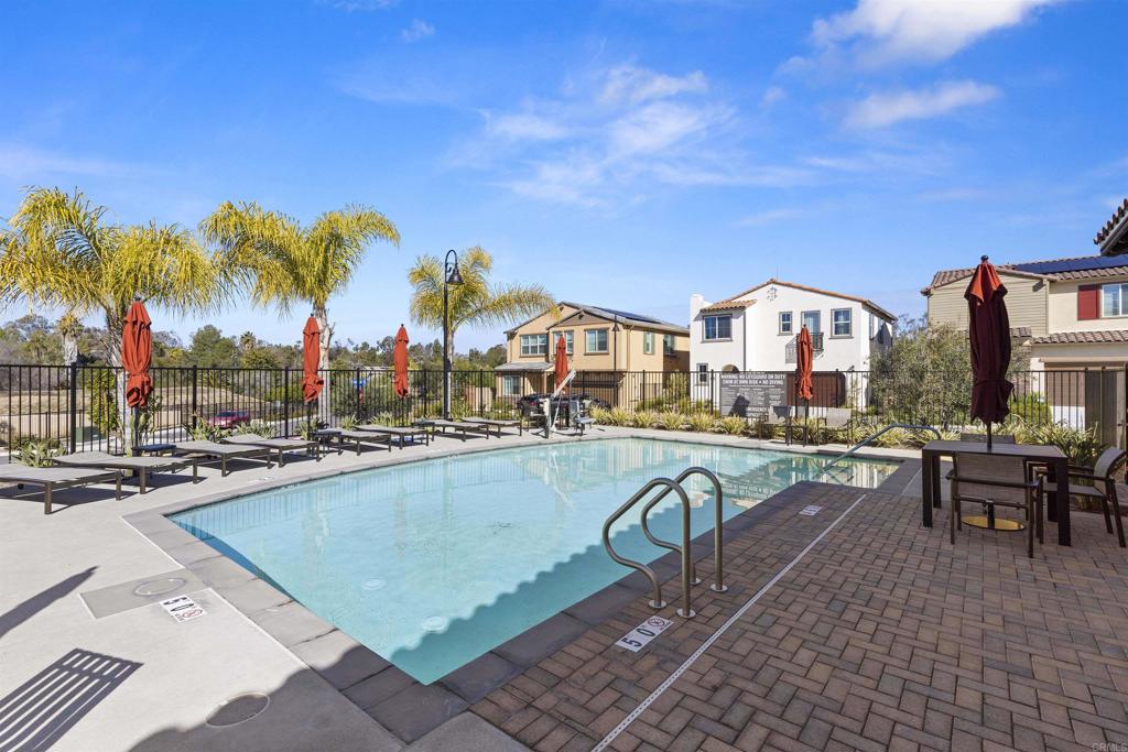 895 Brookdale Drive Vista, CA 92081 - Photo 44 of 45 a view of a swimming pool with a lounge chairs