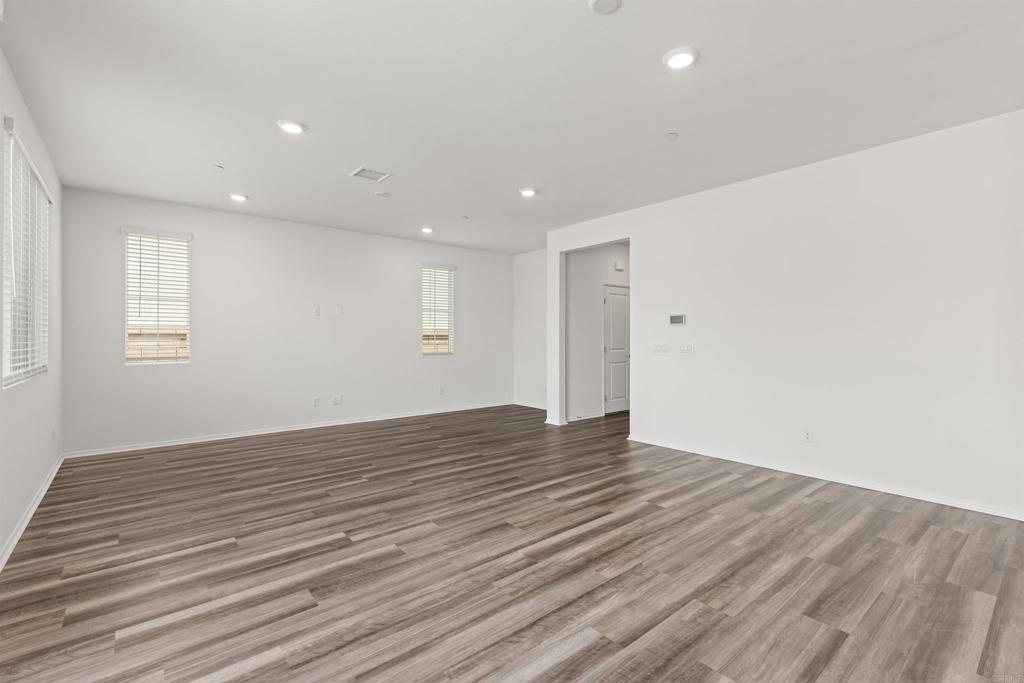 895 Brookdale Drive Vista, CA 92081 - Photo 9 of 45 a view of an empty room with wooden floor and a window