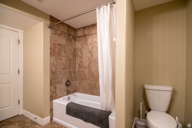 646 East 1400th Street North Mapleton, UT 84664 - Photo 50 of 78 Bathroom featuring a tub and shower combination with brown wall tiling, a white toilet, and neutral wall paint