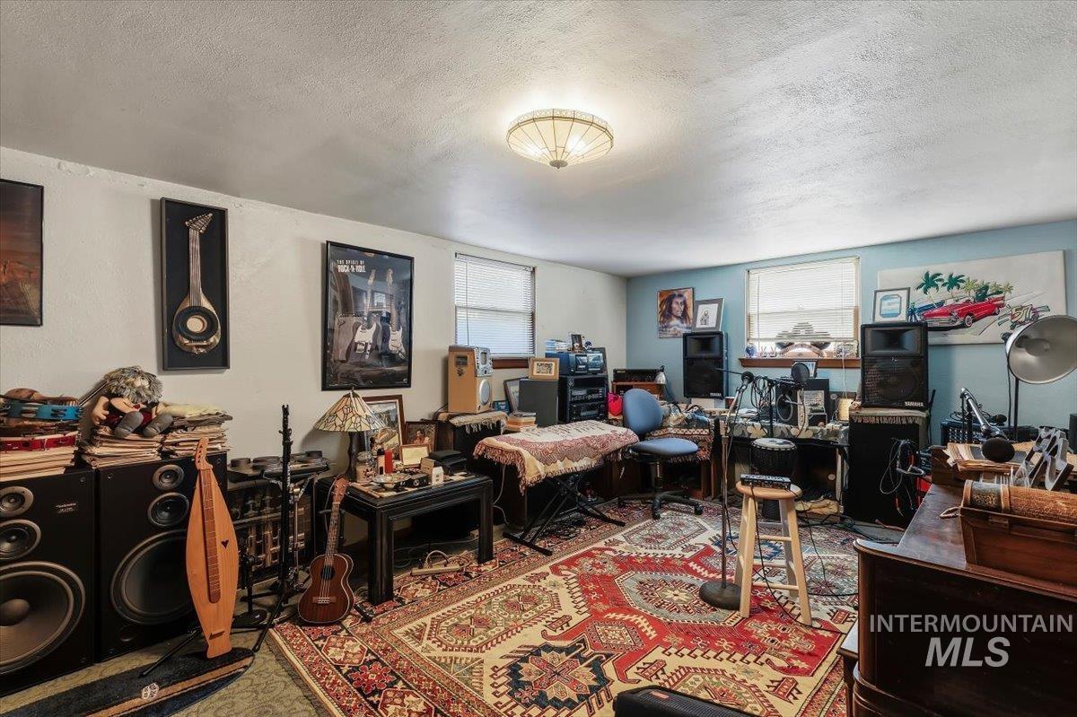 4619 Freemont Street Boise, ID 83706 - Photo 11 of 27 Spacious interior room featuring light-colored walls and a distinctive ceiling-mounted light fixture