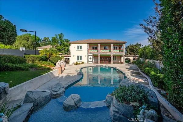 a view of backyard with outdoor seating and green space