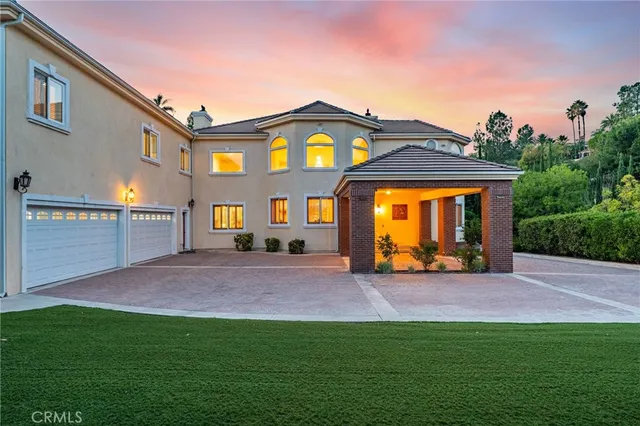 a living room with fireplace furniture and a chandelier