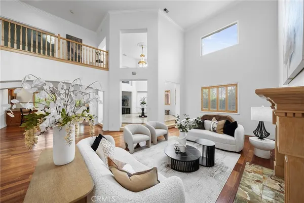a dining room with furniture potted plants and wooden floor