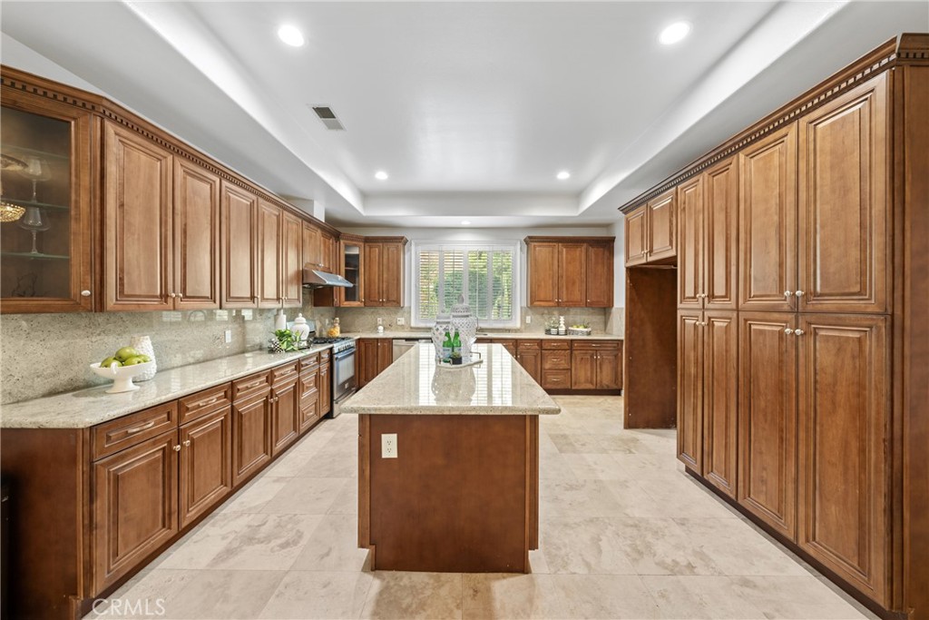 19910 Tennessee Trail Walnut, CA 91789 - Photo 31 of 70 a large kitchen with kitchen island granite countertop wooden cabinets a granite counter tops and a view of living room