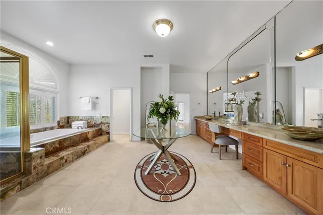 a bathroom with a granite countertop sink a large mirror and a shower