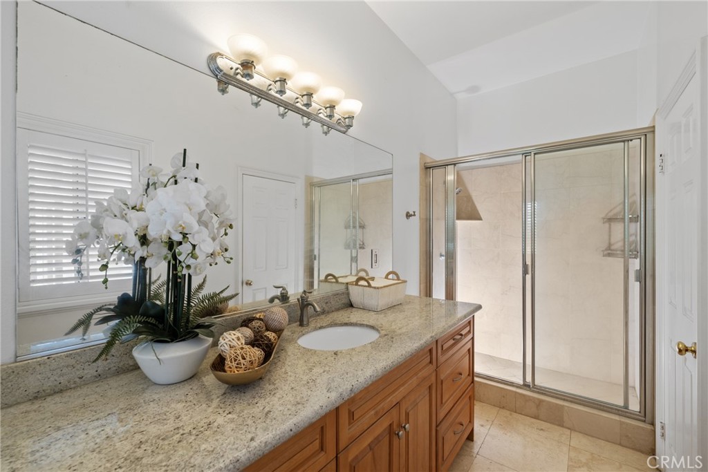 19910 Tennessee Trail Walnut, CA 91789 - Photo 53 of 70 a bathroom with a granite countertop sink a large mirror and a shower