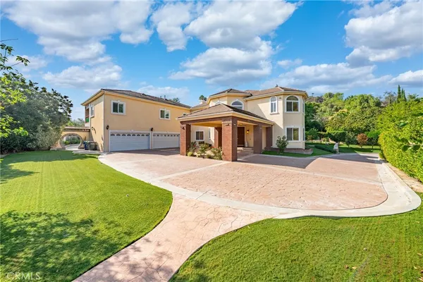 a view of a house with swimming pool and sitting area