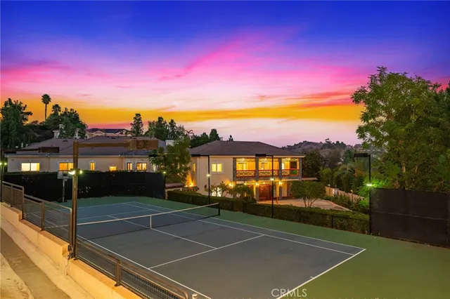 a view of a house with pool and chairs