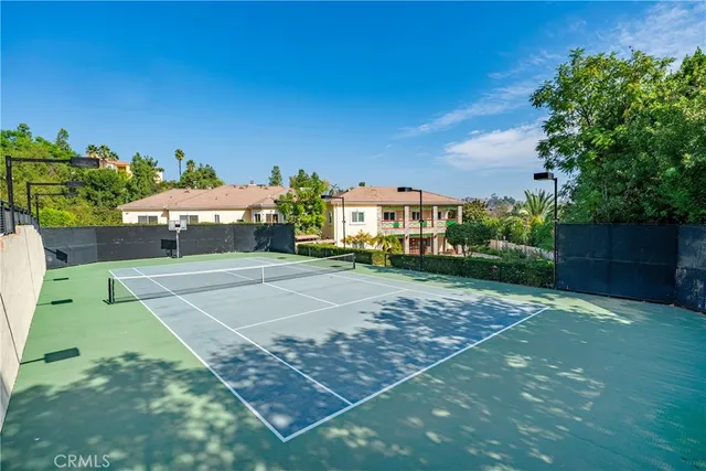 a view of a swimming pool and lounge chairs in back yard