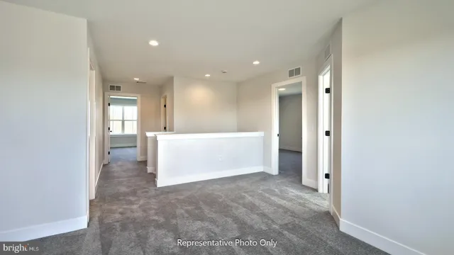 a view of a hallway to kitchen with a sink