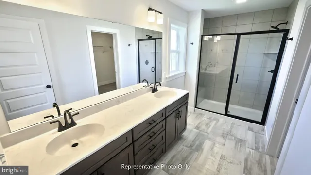 a bathroom with a double vanity sink mirror double and shower