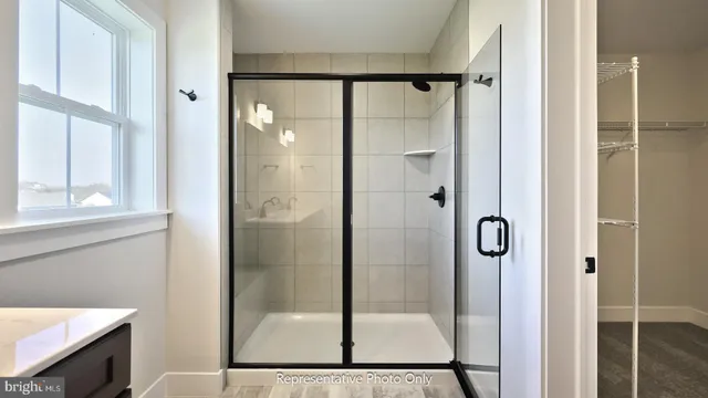 a bathroom with a glass shower door