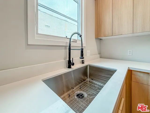 a view of kitchen and hall with wooden floor