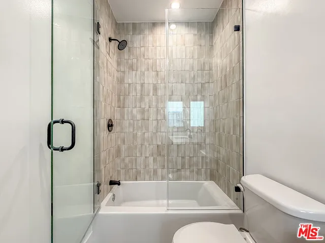 a bathroom with a double vanity sink mirror and shower