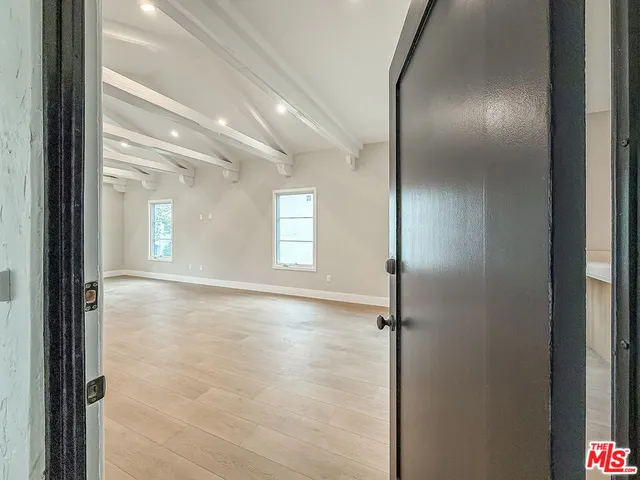 a view of livingroom and hallway with wooden floor