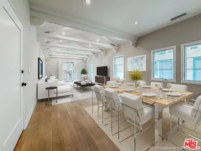 a view of a hallway with wooden floor and a glass door