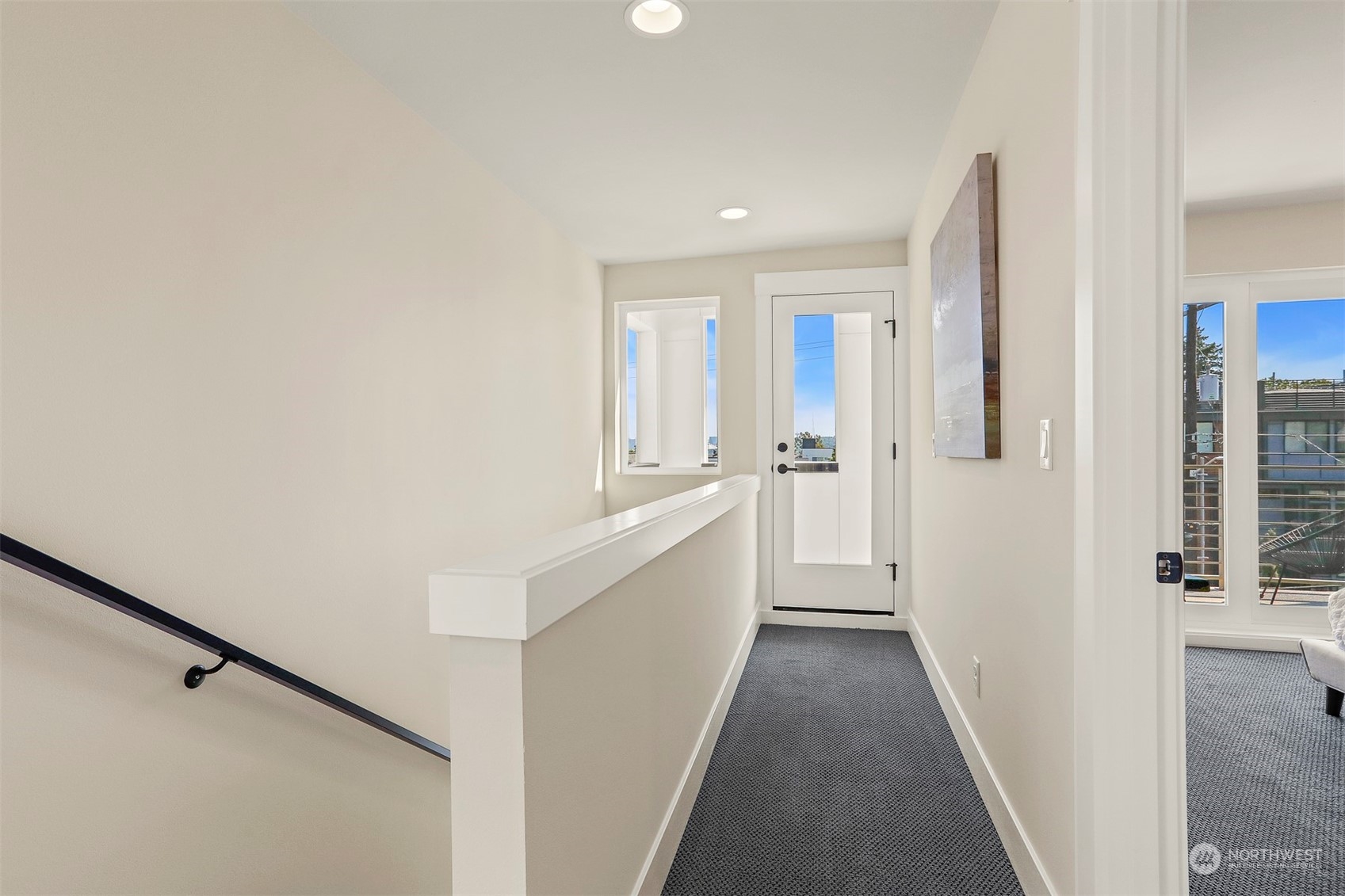 520 North 48th Street, Unit B Seattle, WA 98103 - Photo 15 of 38 a view of a hallway with white walls and wooden floor