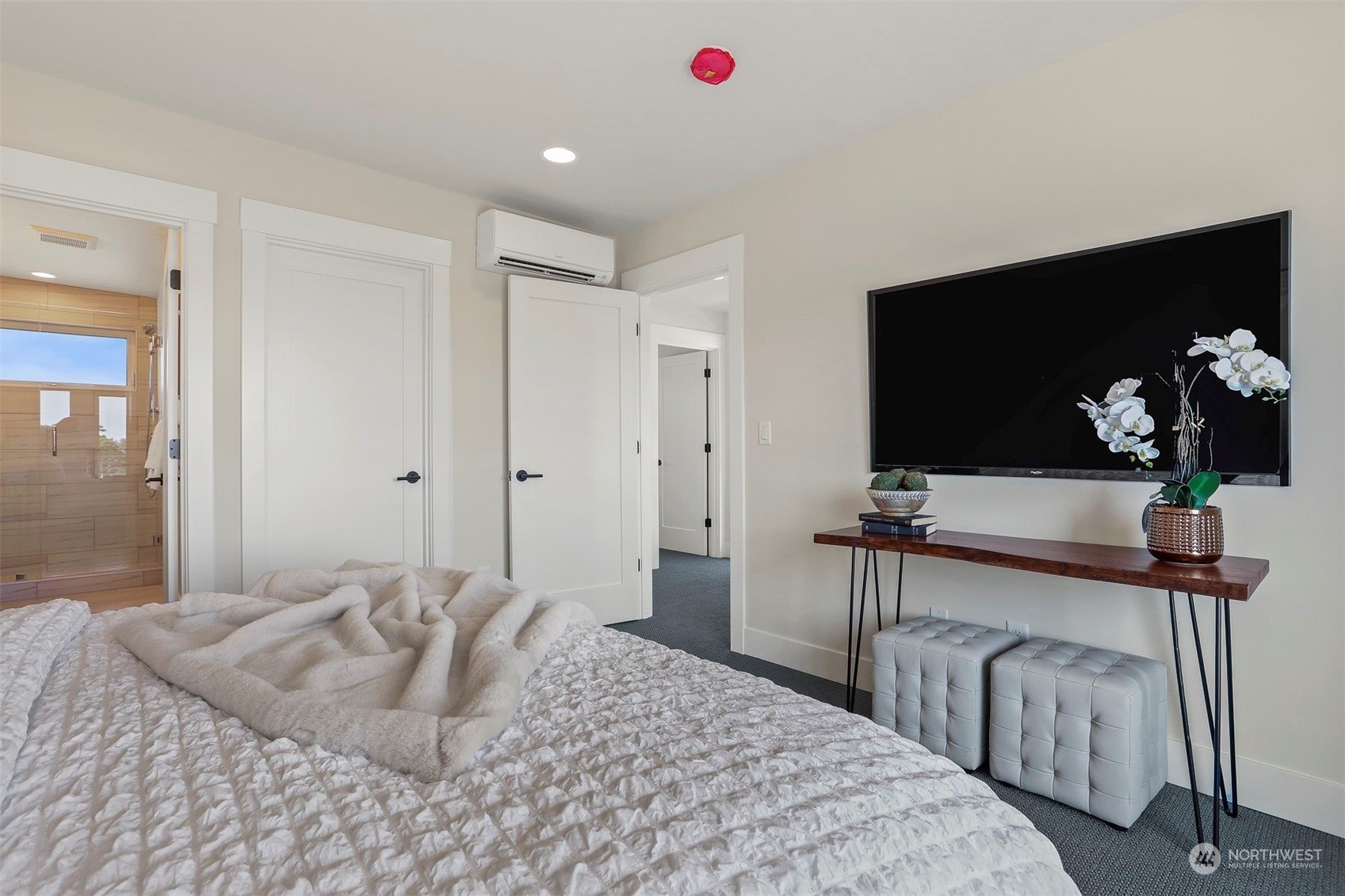 520 North 48th Street, Unit B Seattle, WA 98103 - Photo 26 of 38 a bedroom with a bed and a flat screen tv