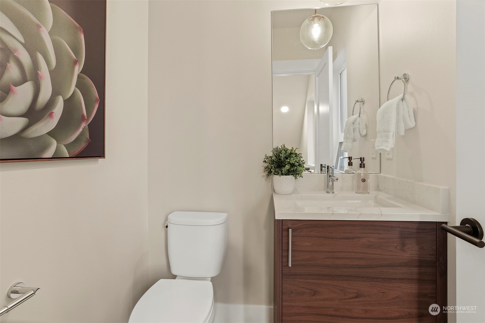 520 North 48th Street, Unit B Seattle, WA 98103 - Photo 27 of 38 a bathroom with a sink vanity mirror and toilet